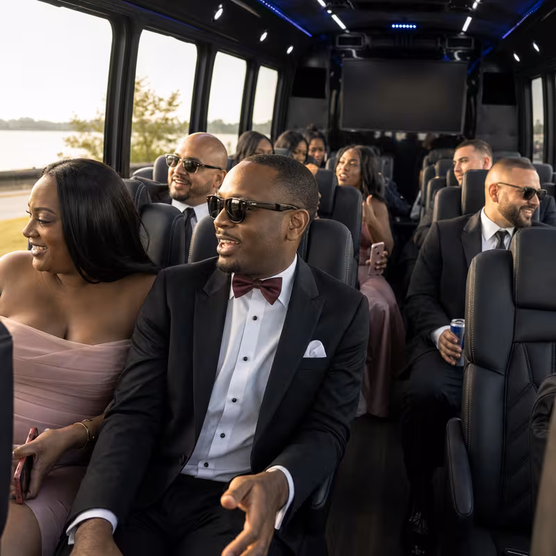 Wedding guests seated inside a Bronx party bus