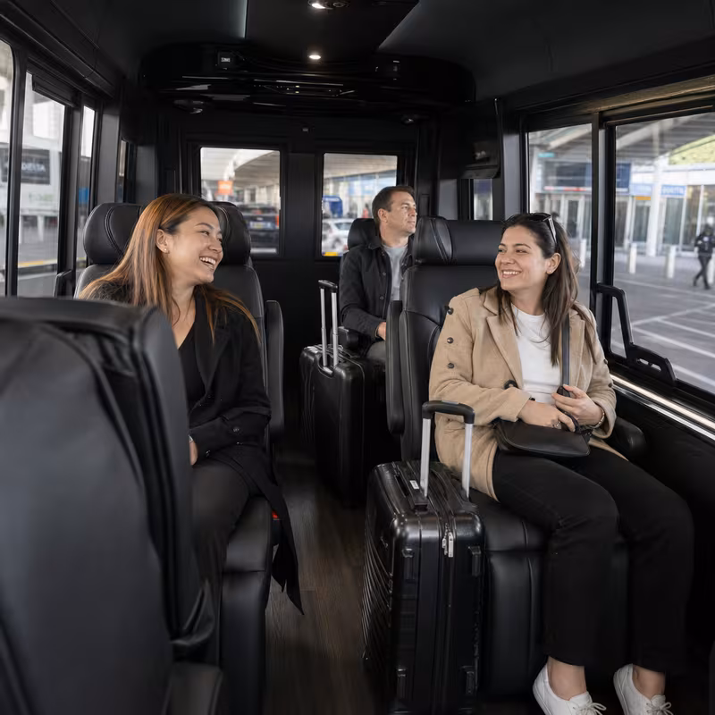 Passengers loading luggage while boarding an Bronx group shuttle