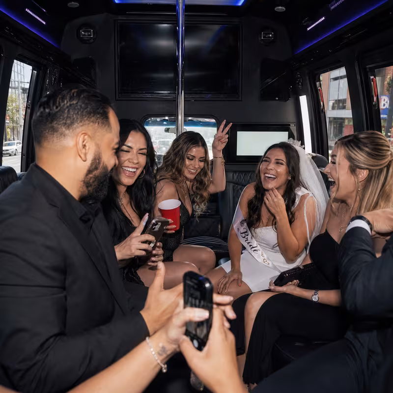 Party bus interior with wraparound leather seating and LED lighting in Bronx