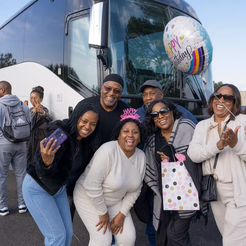 Passengers loading luggage while boarding an Bronx group shuttle