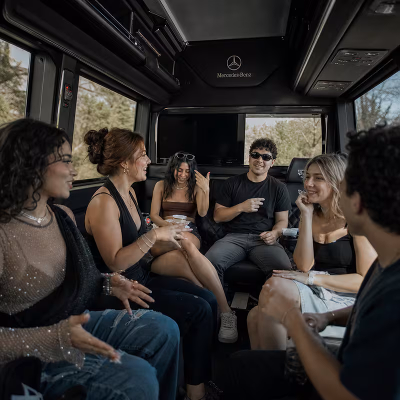 Group boarding a white charter bus for Concert Transportation transportation in Bronx