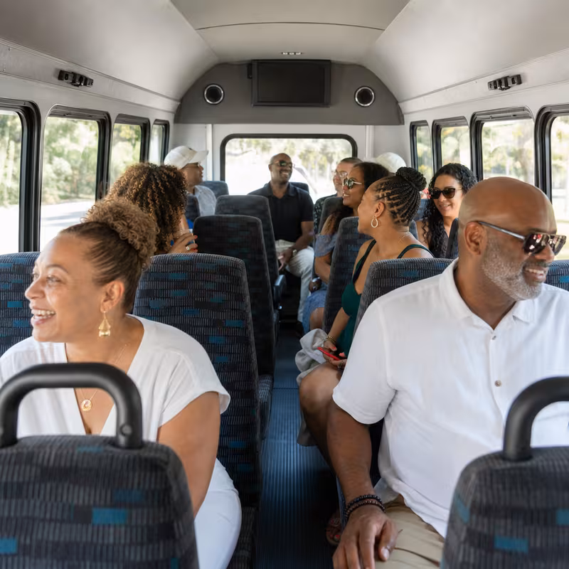 Group boarding a white charter bus for Private Event Transportation transportation in Bronx