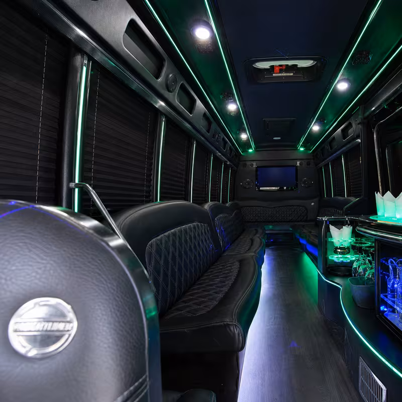 Party bus interior with wraparound leather seating and LED lighting in Bronx