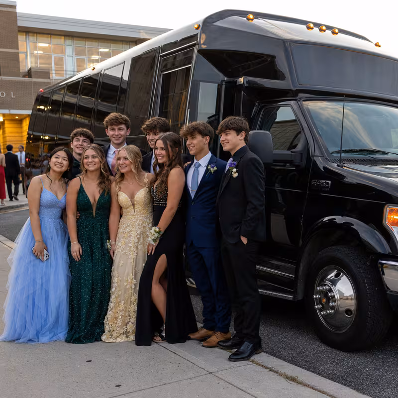 Group boarding a white charter bus for Prom & Homecoming Transportation transportation in Bronx