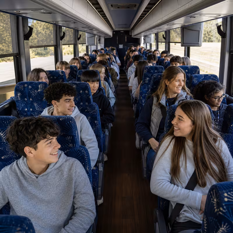 Group boarding a white charter bus for School Transportation transportation in Bronx
