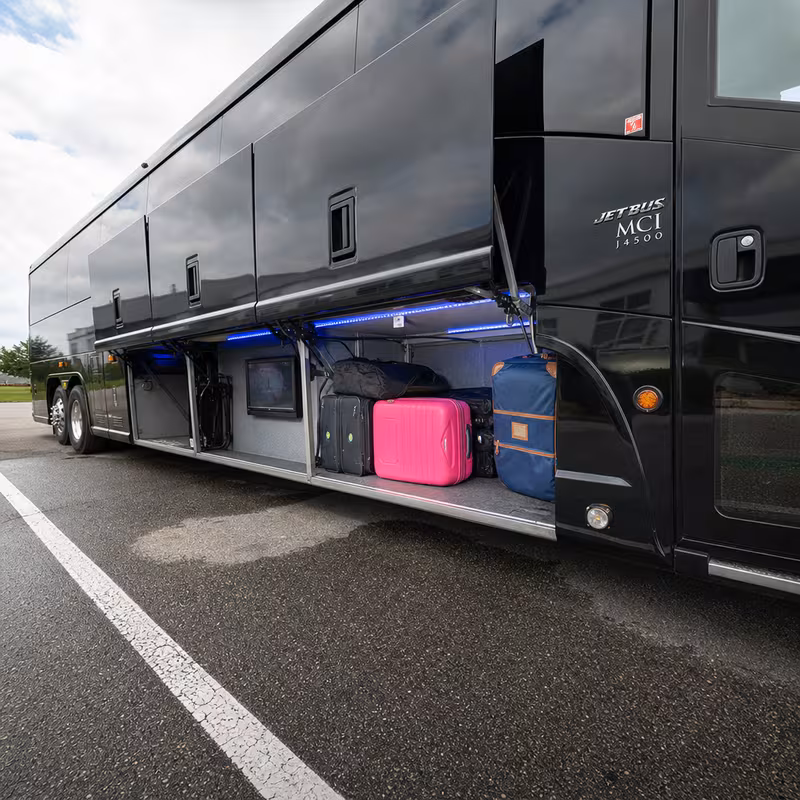 Party bus interior with wraparound leather seating and LED lighting in Bronx
