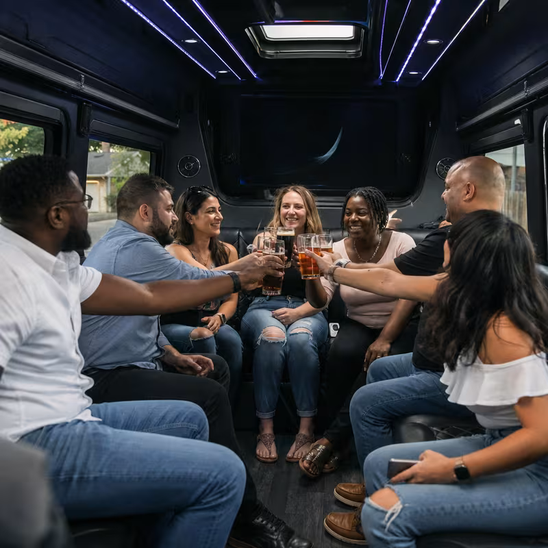 Group boarding a white charter bus for Winery & Brewery Tour Transportation transportation in Bronx